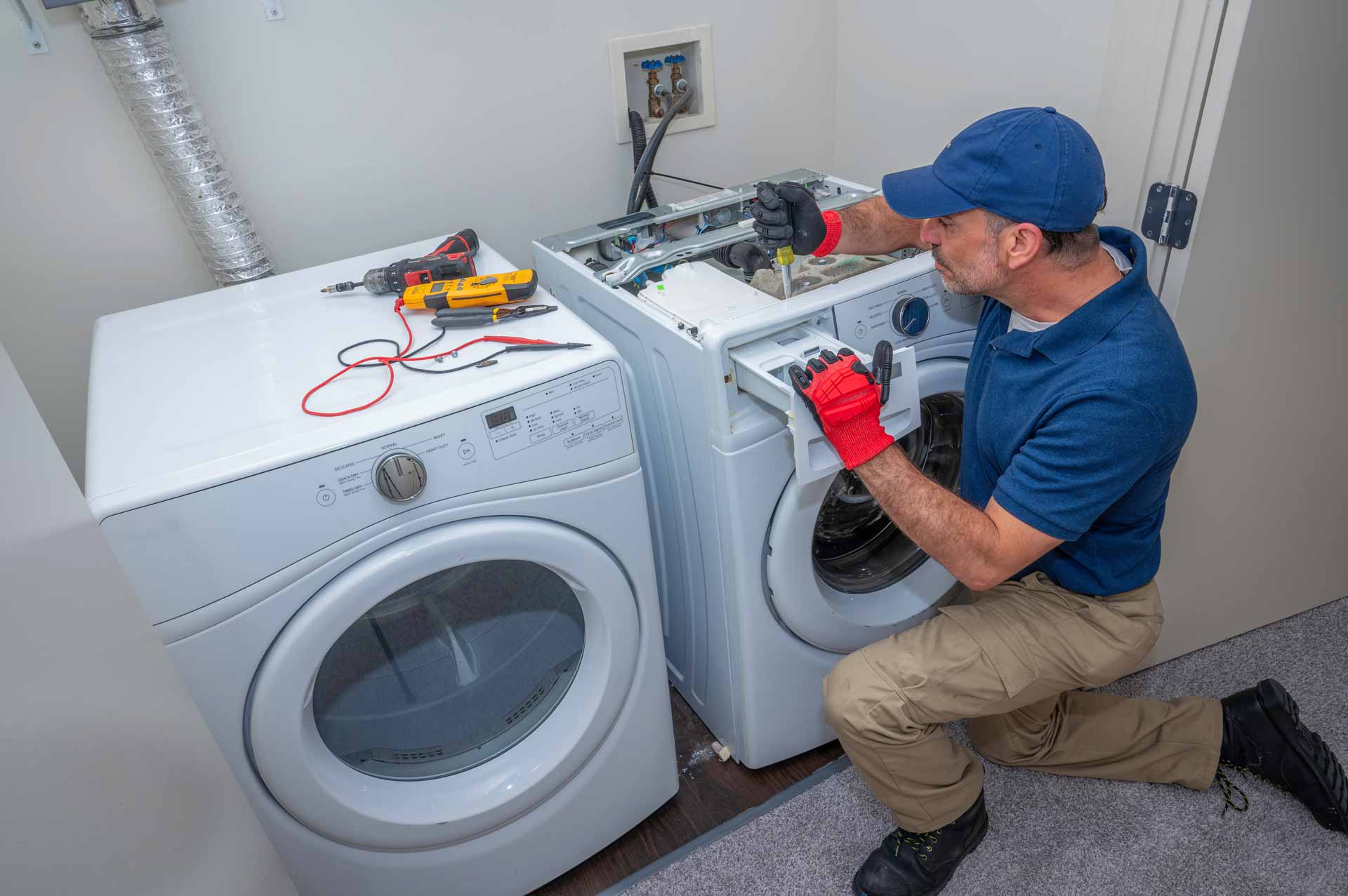 Technician repairing the detergent drawer on a washing machine