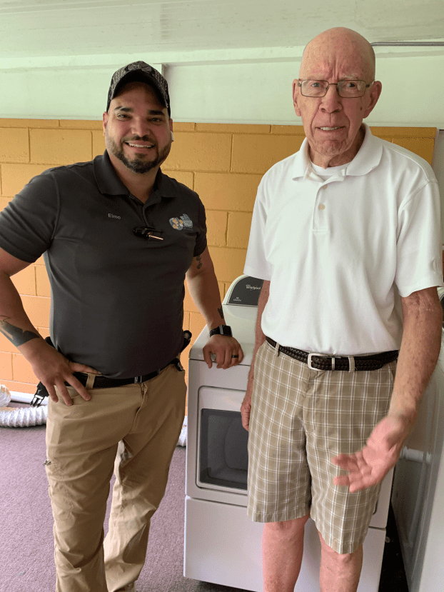 Technician from Elmo's Appliance Repair posing with a satisfied customer