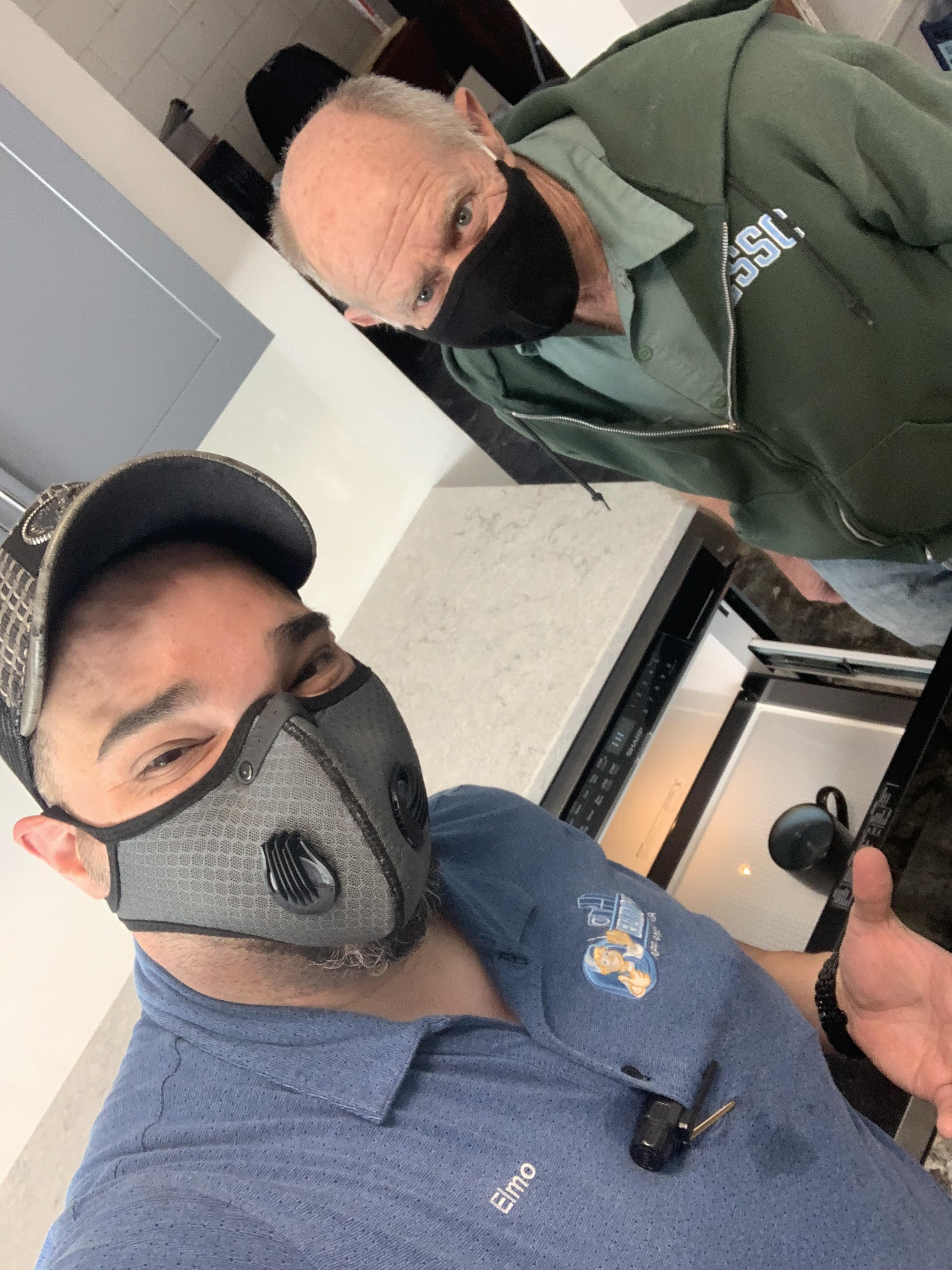 Technician from Elmo's Appliance Repair posing with a satisfied customer