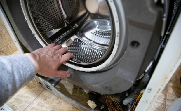 Hand reaching in to washer/dryer drum
